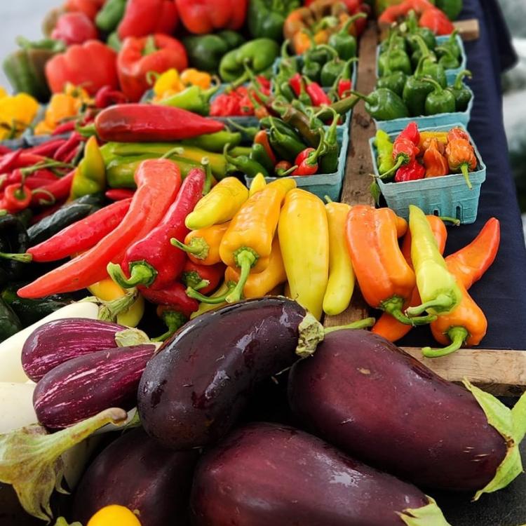  an array of fruits and vegetables on table at farmers market